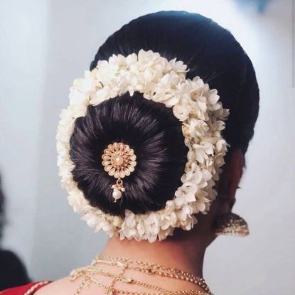 Charm Your Wedding Look By These Amazing Bun Hairstyles! - Weddingplz Blog  | Bridal hair buns, Hair style on saree, Wedding bun hairstyles